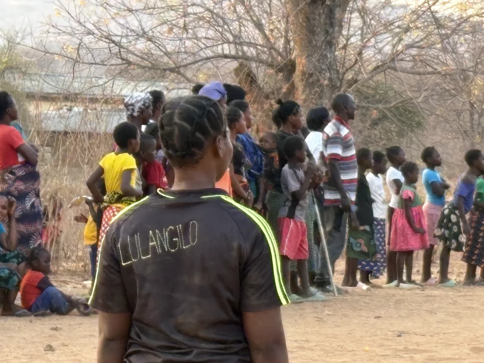 Women and children of Munyama Village gathered for a community event
