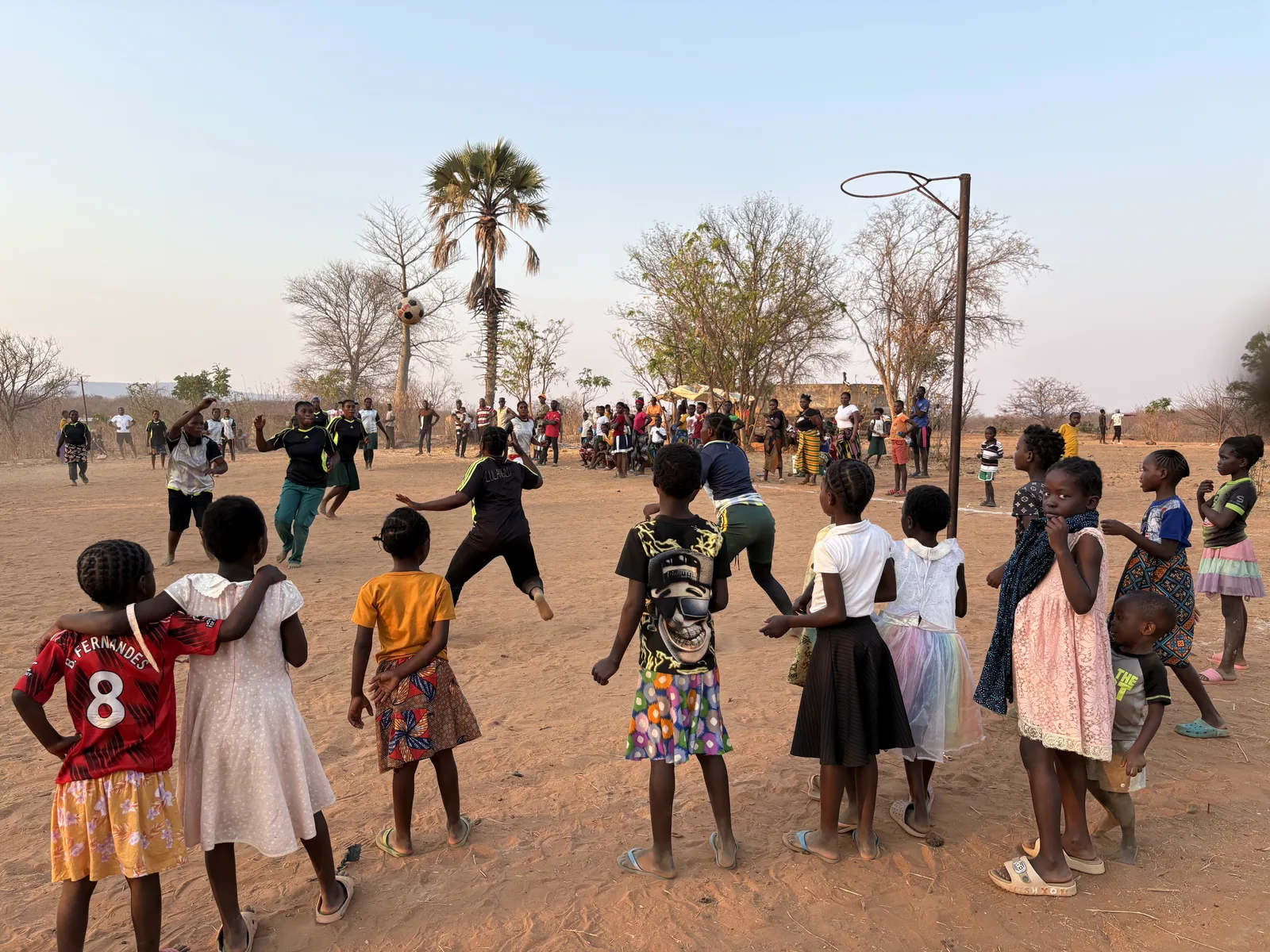 Children and spectators gathered around the netball court at the Munyama tournament